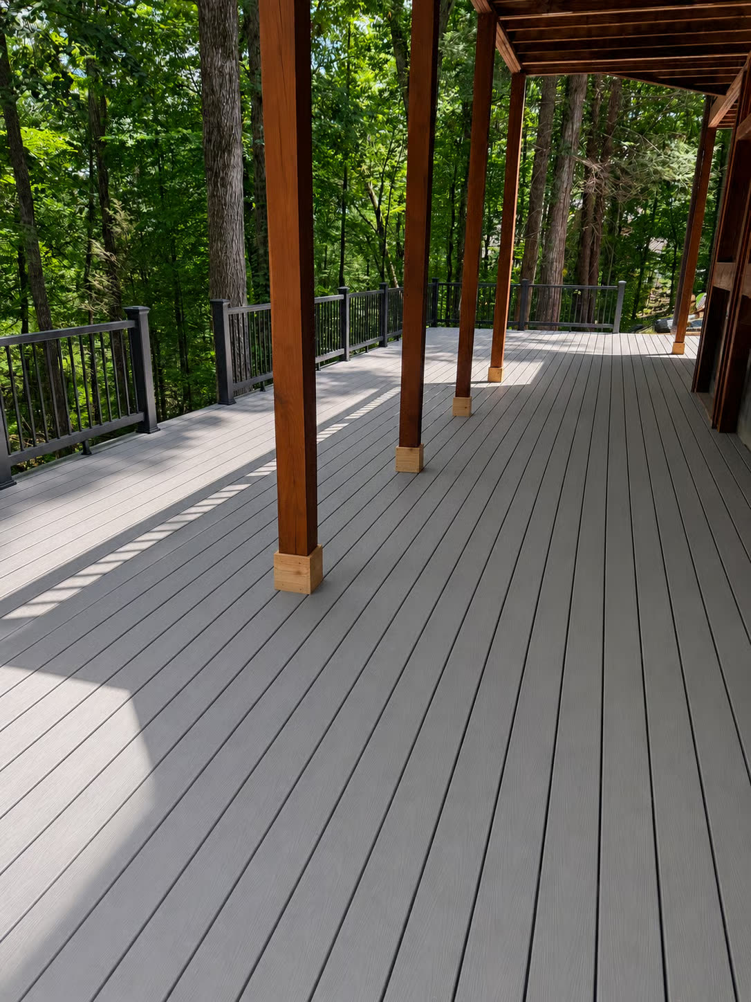 Covered deck with wood ceiling and railing built by EVR Construction