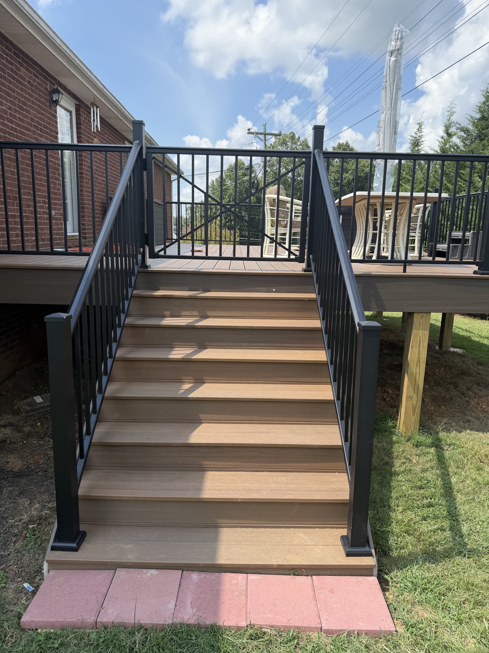 Raised custom wood deck with white rail columns in East Tennessee